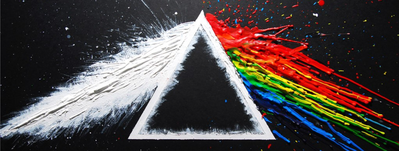 Photograph of white paint entering a prism and being splint into individual colour components