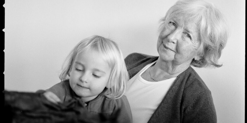 A black and white photo of a grandmother with her grandchild