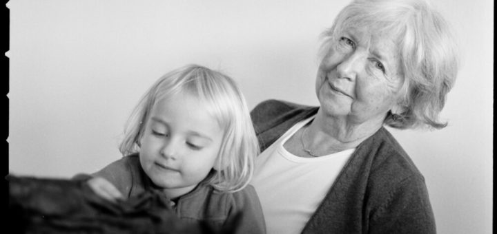 A black and white photo of a grandmother with her grandchild